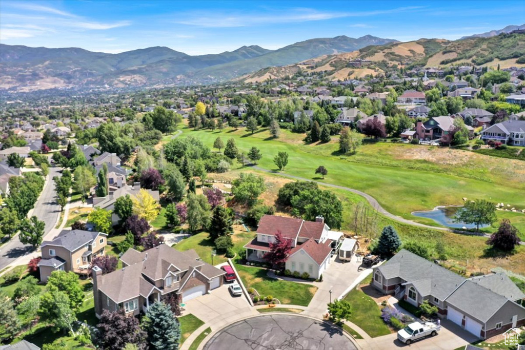 Aerial perspective of suburban area featuring a local golf course and a water and mountain view
