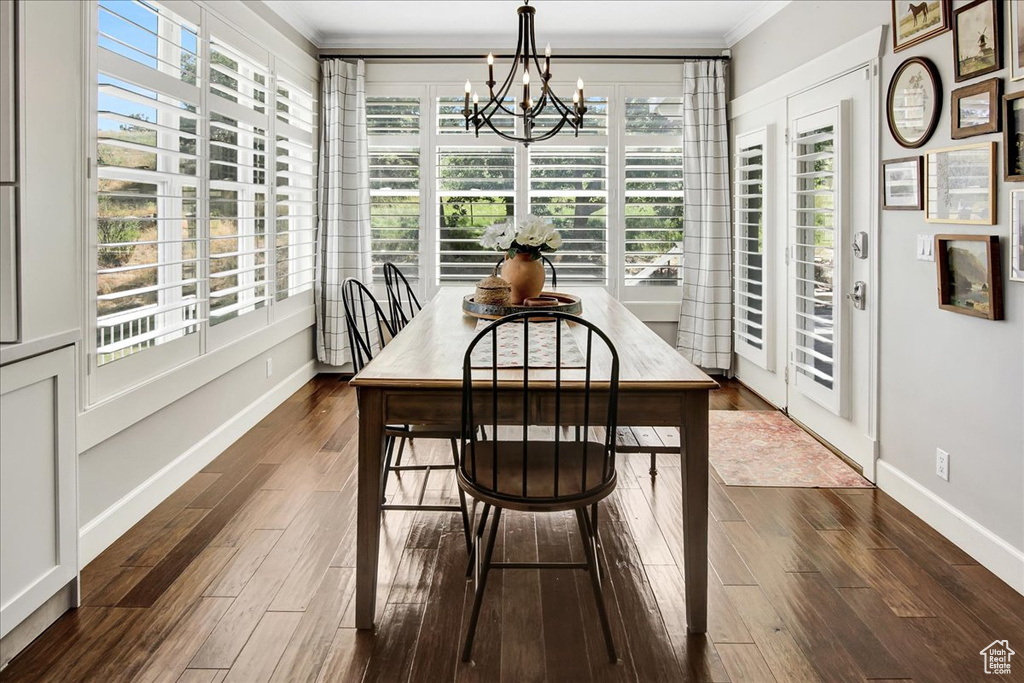 Sunroom featuring a chandelier and plenty of natural light