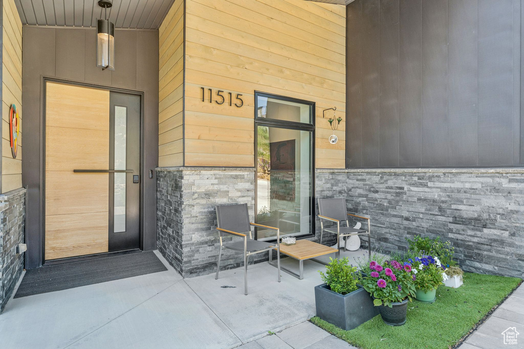 Entrance to property with stone siding