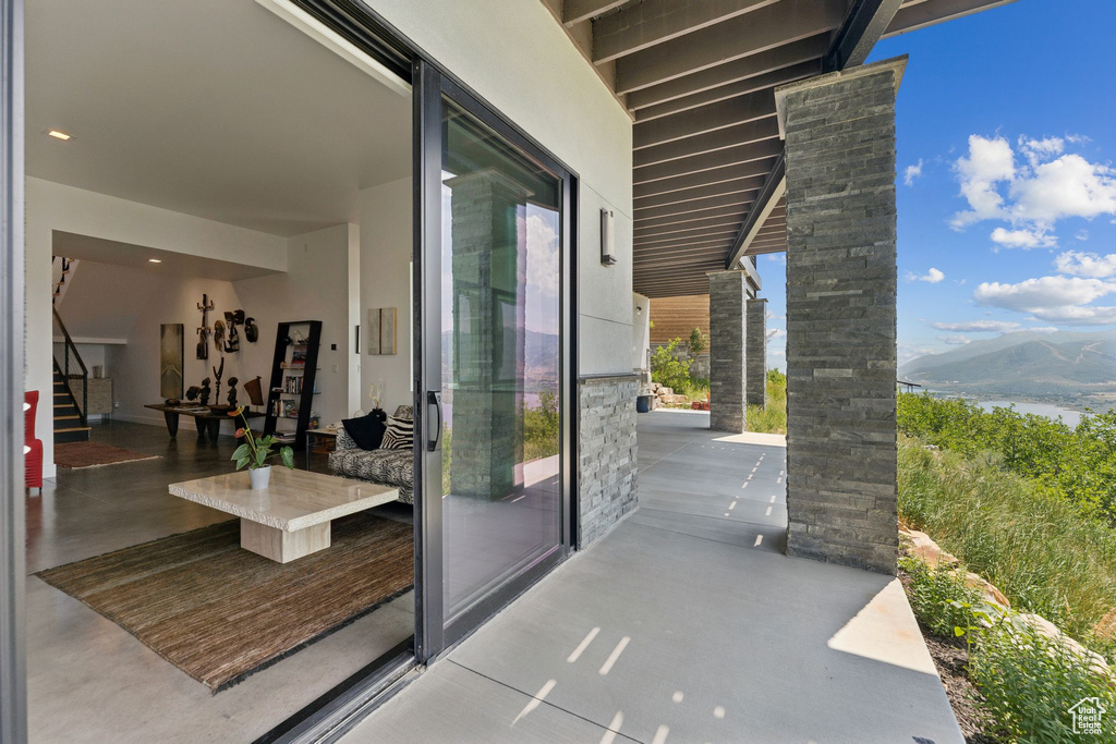 View of patio / terrace featuring a water and mountain view