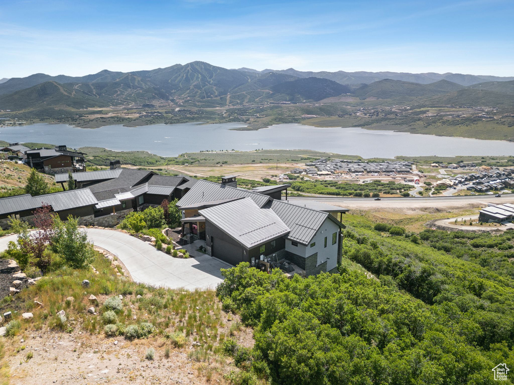 View of subject property with a water and mountain view