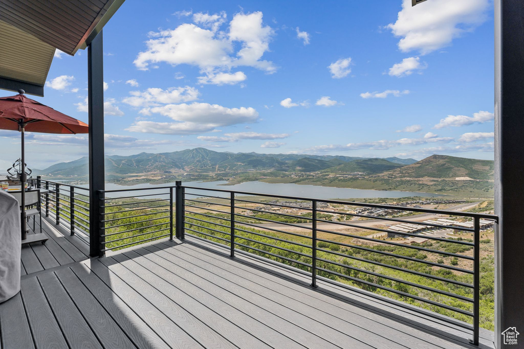 Wooden deck featuring a water and mountain view
