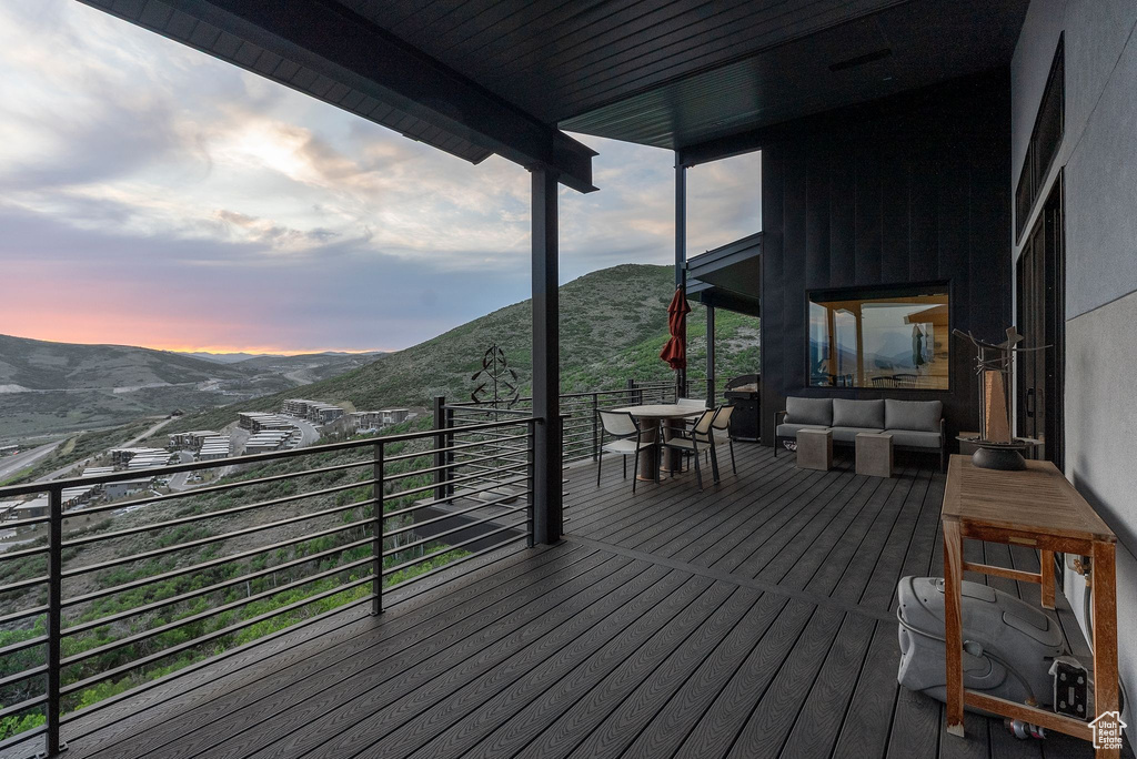 Wooden deck featuring a mountain view and an outdoor living space