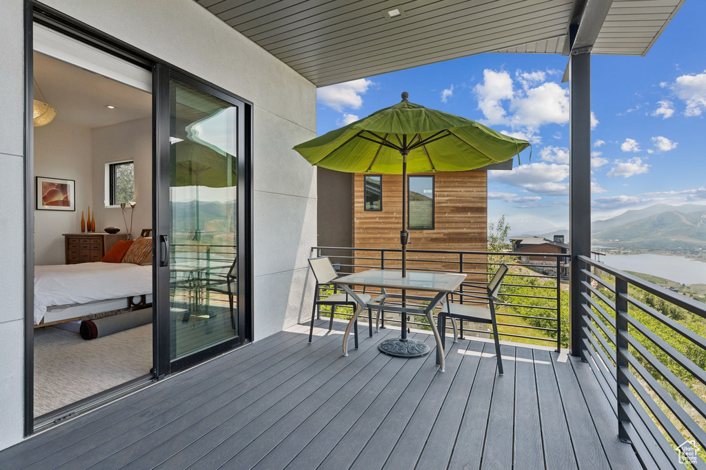 Deck featuring a water and mountain view