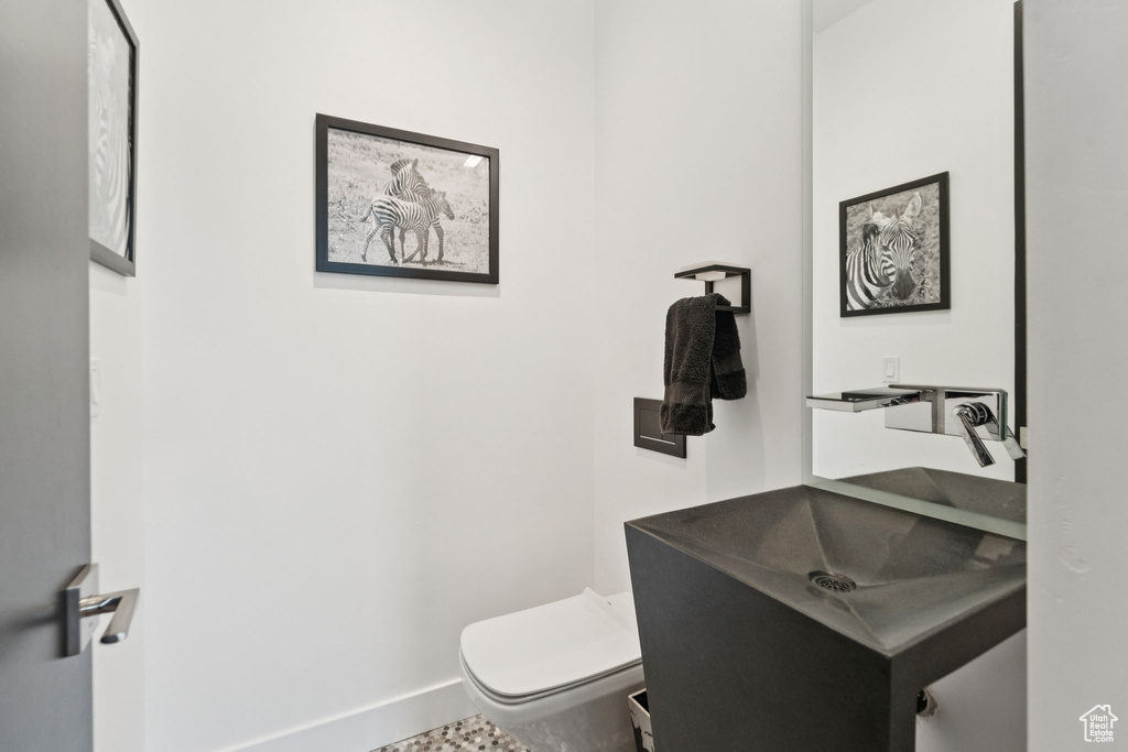 Half bathroom featuring toilet and vanity