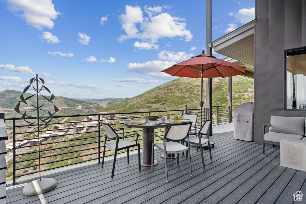 Wooden terrace with a mountain view and outdoor dining area