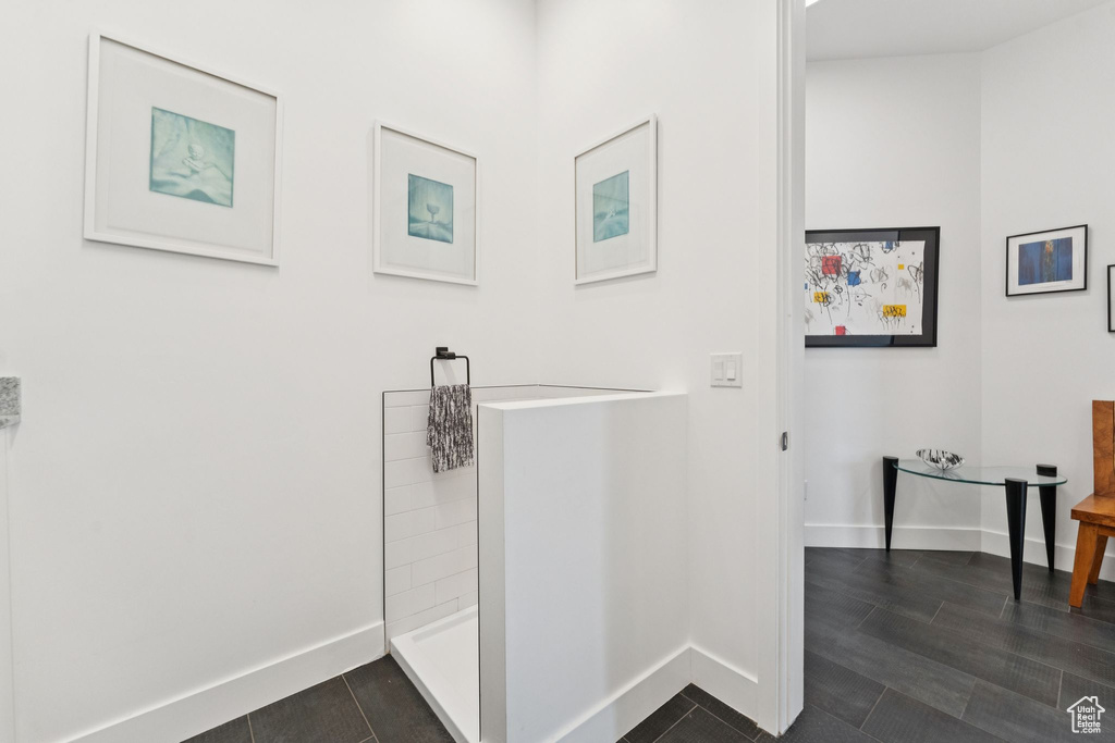 Bathroom with a shower and tile patterned flooring