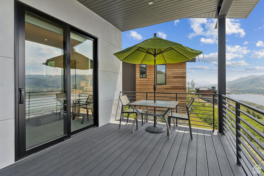 Wooden deck with a water and mountain view