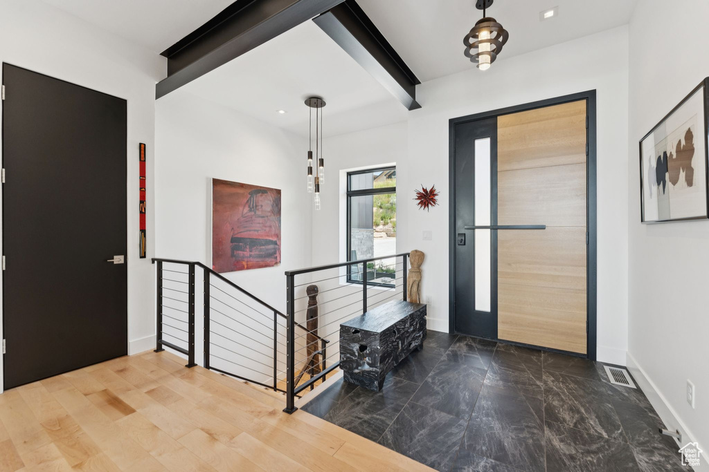 Entrance foyer with marble finish flooring, beam ceiling, and recessed lighting