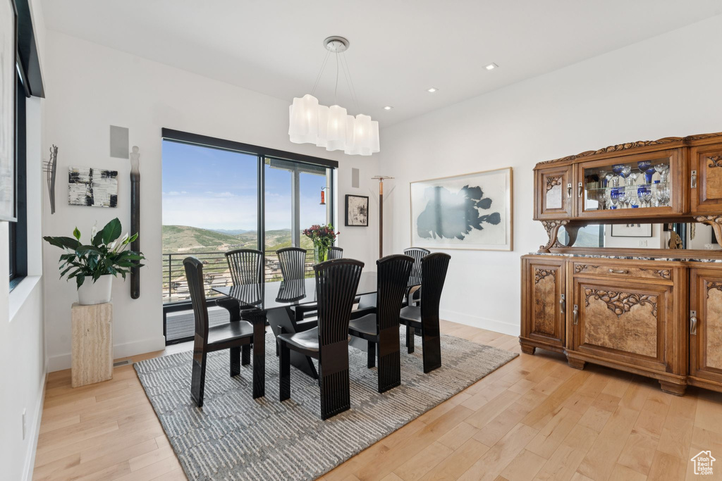 Dining space with light wood finished floors, recessed lighting, and a chandelier
