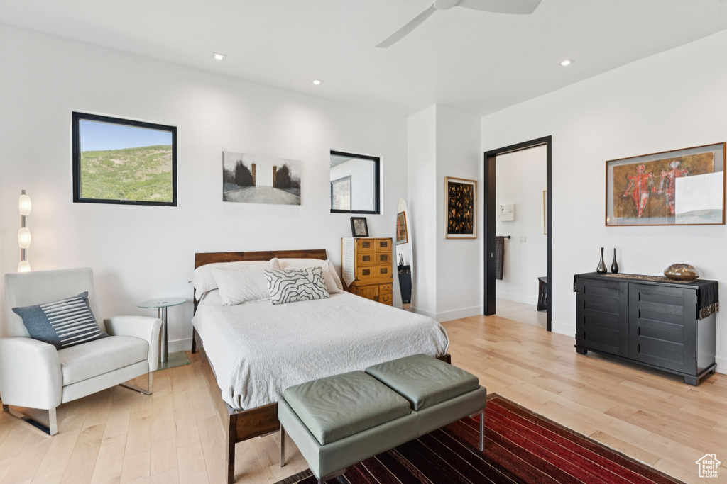 Bedroom featuring light wood-type flooring, a ceiling fan, and recessed lighting