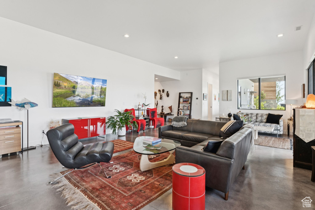 Living room with concrete flooring and recessed lighting