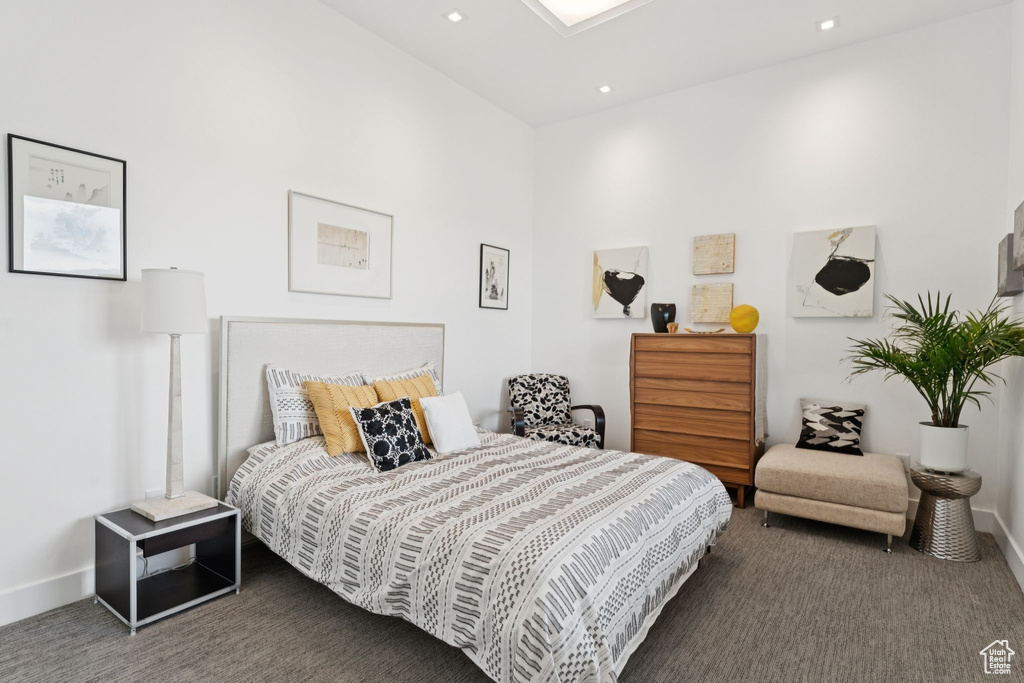 Carpeted bedroom with baseboards and recessed lighting