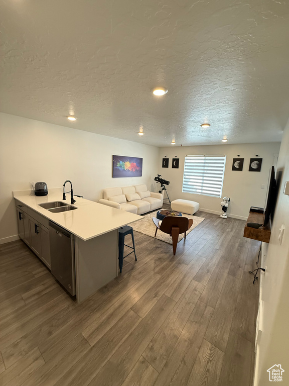 Living room with dark wood-type flooring, a textured ceiling, and recessed lighting