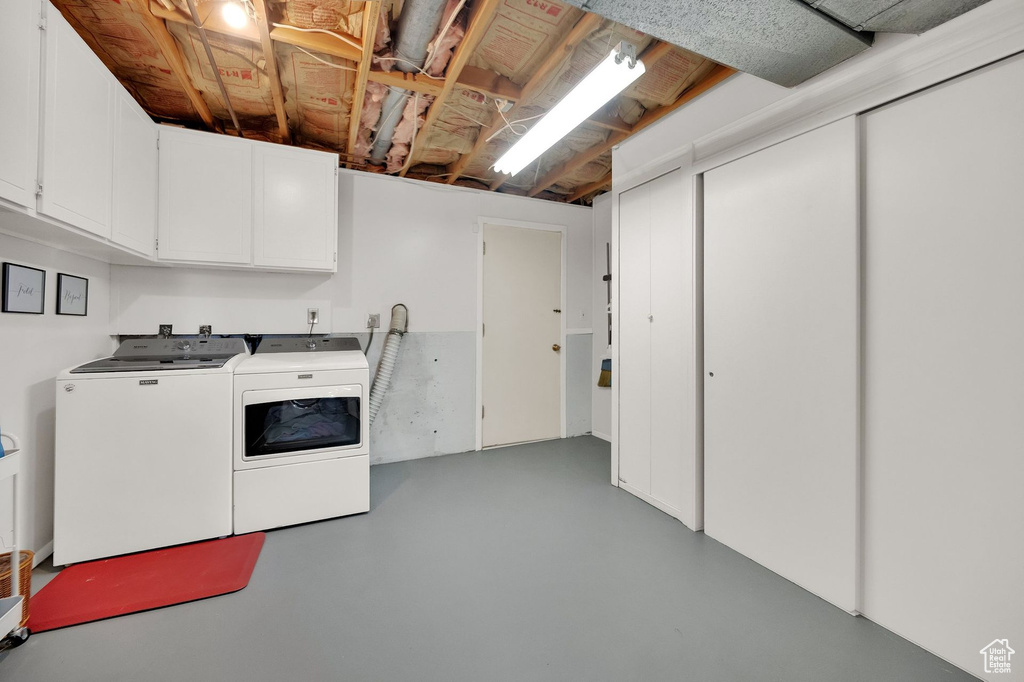 Laundry room with independent washer and dryer and cabinet space