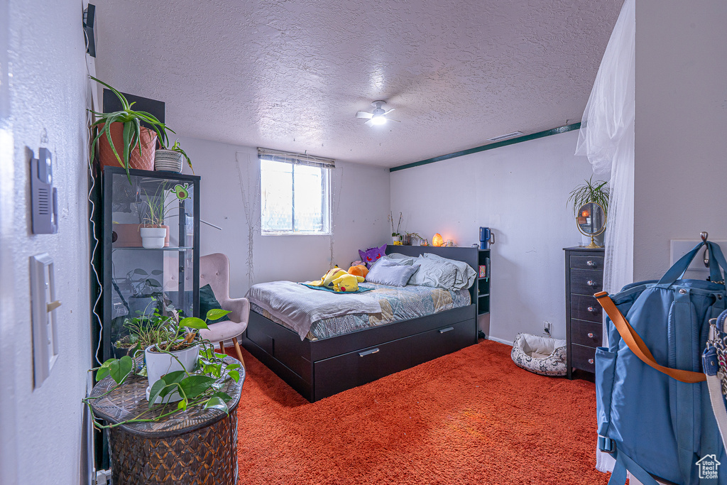 Carpeted bedroom with a textured ceiling