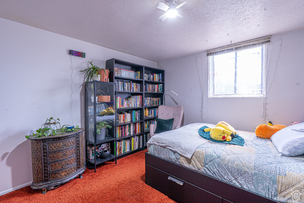 Bedroom with carpet flooring and a textured ceiling