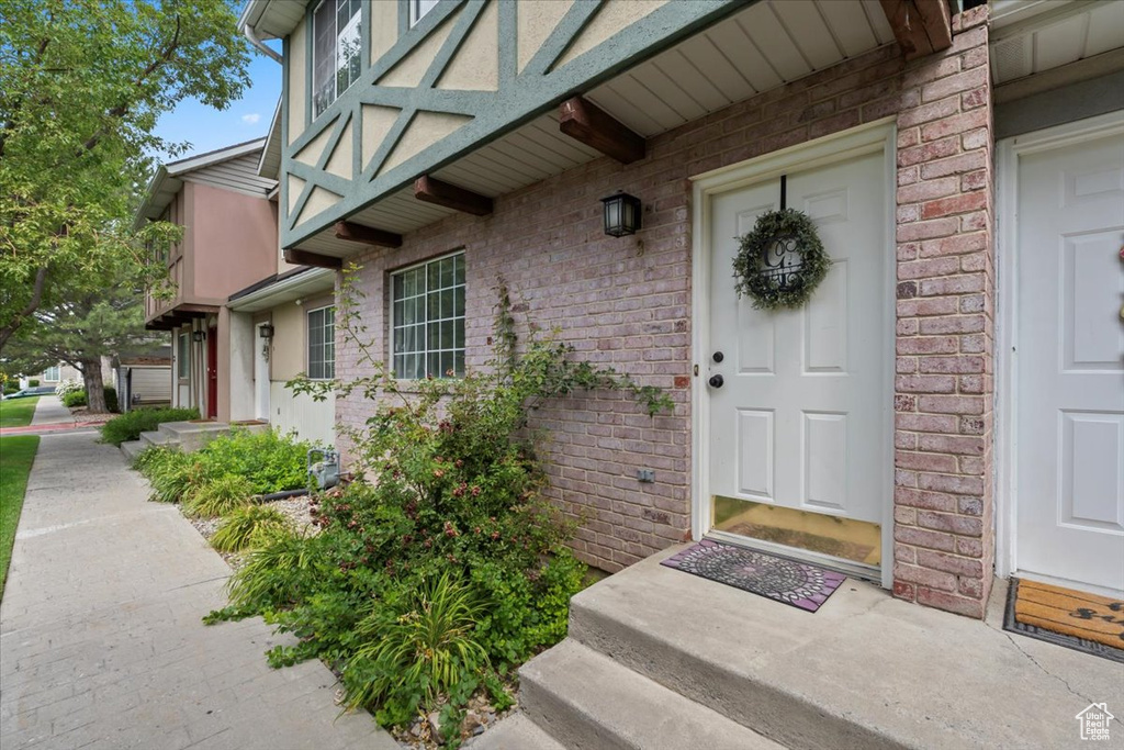Entrance to property with brick siding