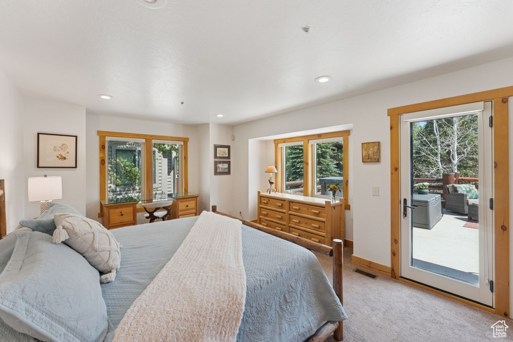 Carpeted bedroom with access to outside and recessed lighting