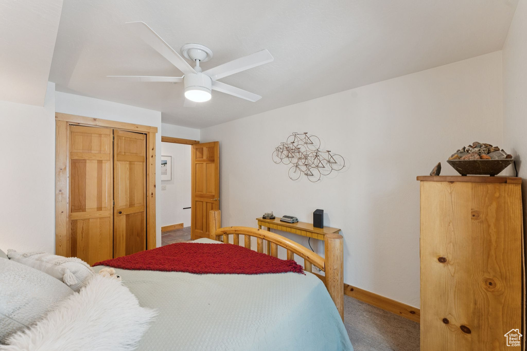 Bedroom with carpet flooring, a closet, and ceiling fan