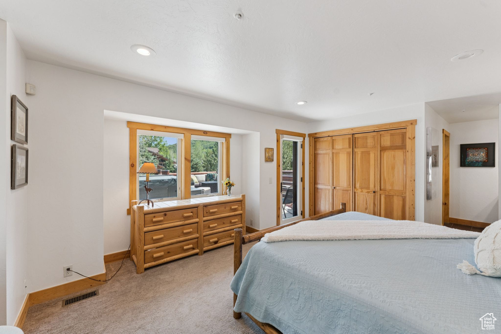 Bedroom featuring light colored carpet and recessed lighting