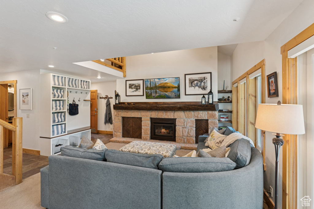 Living room with recessed lighting and a fireplace