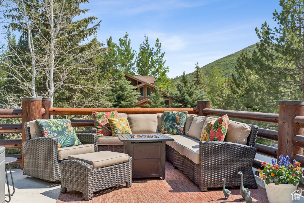 View of patio / terrace with a mountain view and an outdoor living space with a fire pit