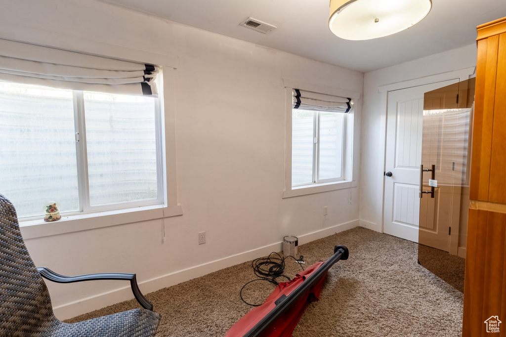 Workout room featuring light colored carpet and baseboards