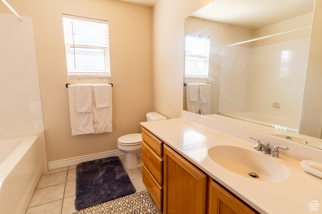 Full bath featuring vanity, shower / bath combination, and tile patterned floors