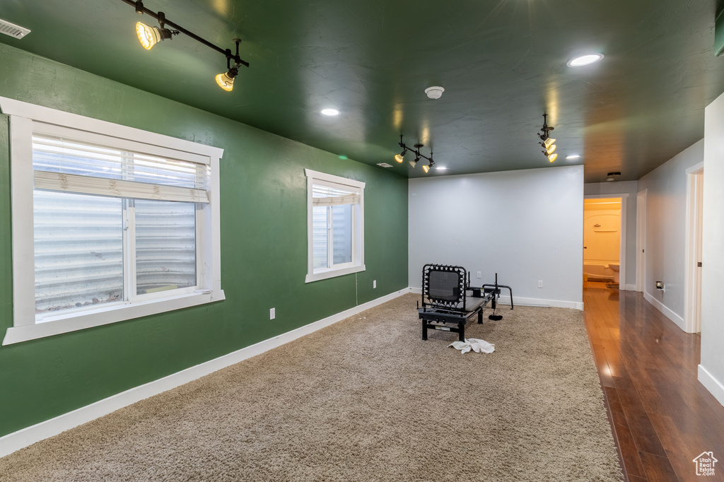 Office space with rail lighting, dark wood finished floors, and recessed lighting