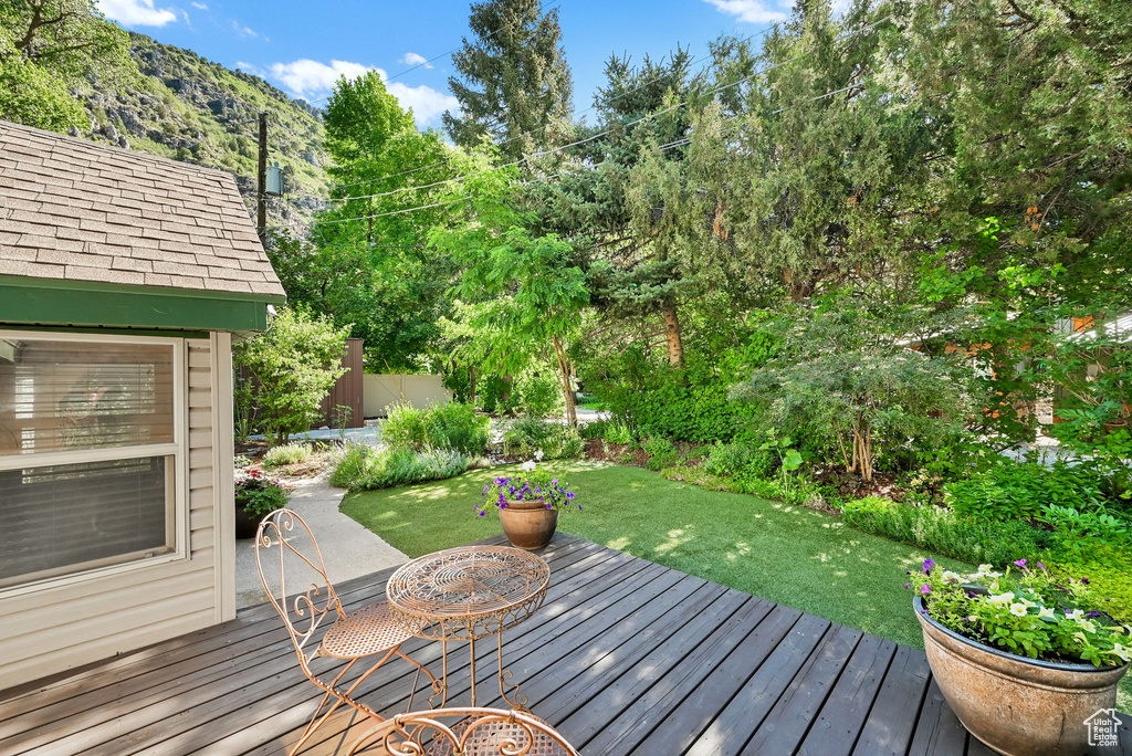 Wooden deck featuring a lawn