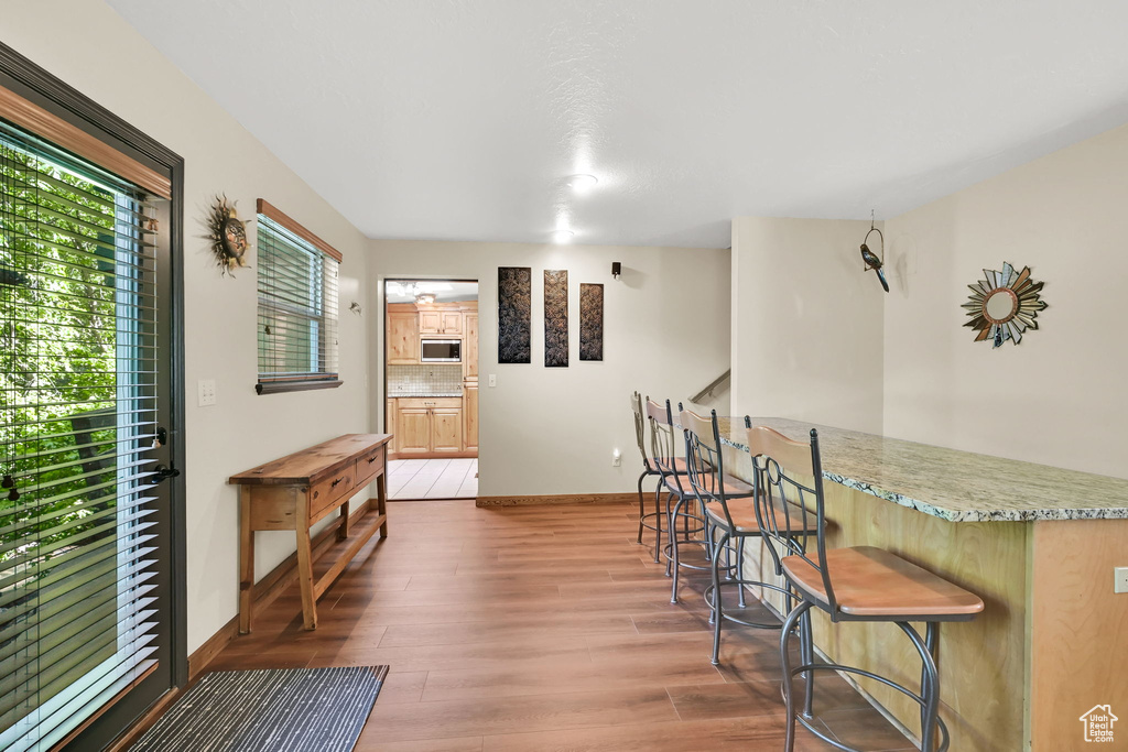 Dining space featuring wood finished floors and stairway