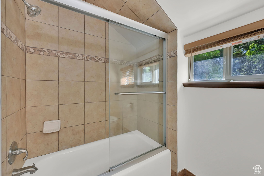 Bathroom featuring enclosed tub / shower combo