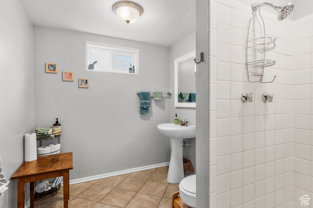Bathroom featuring a tile shower and tile patterned floors