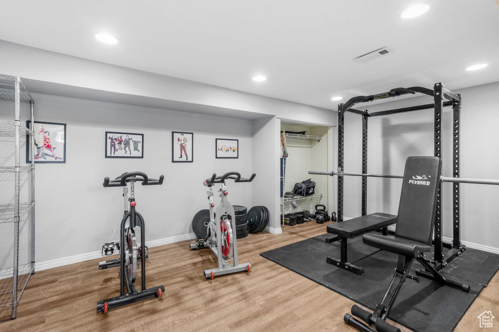 Exercise room with recessed lighting and wood finished floors