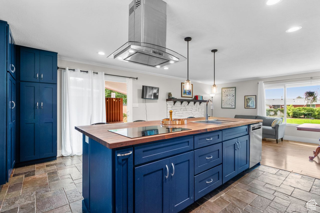 Kitchen featuring wooden counters, island range hood, black electric cooktop, blue cabinetry, and recessed lighting