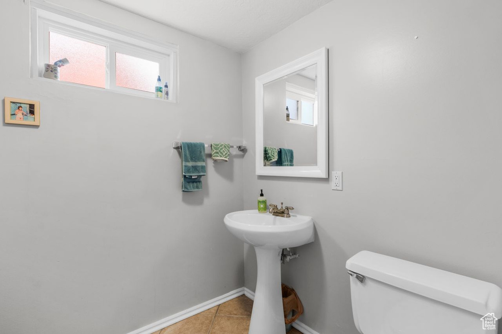 Bathroom with toilet and tile patterned floors