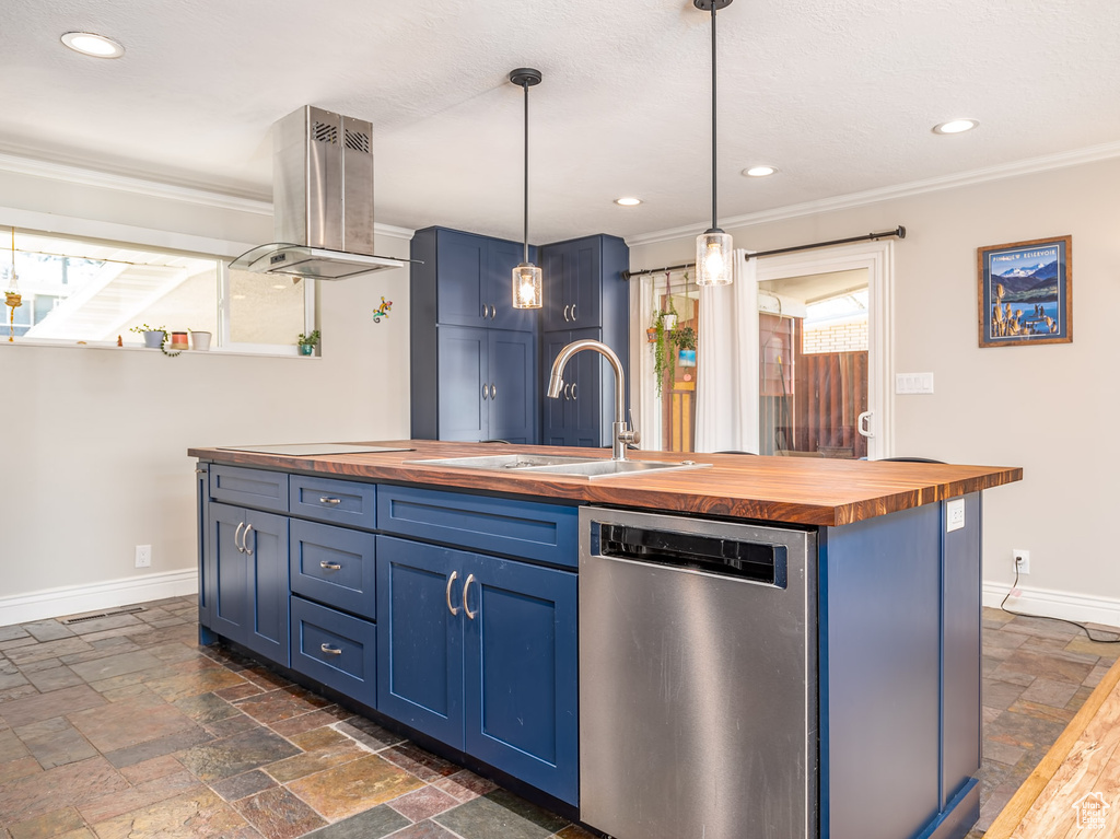 Kitchen with butcher block counters, dishwasher, blue cabinetry, stone tile floors, and ornamental molding