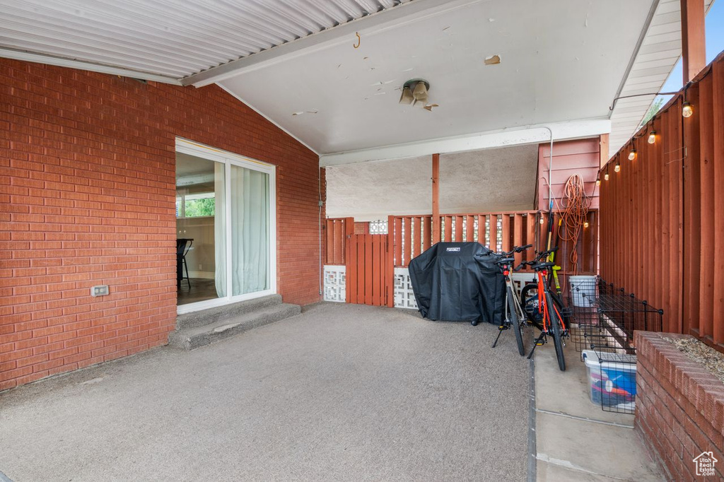 View of patio with a grill