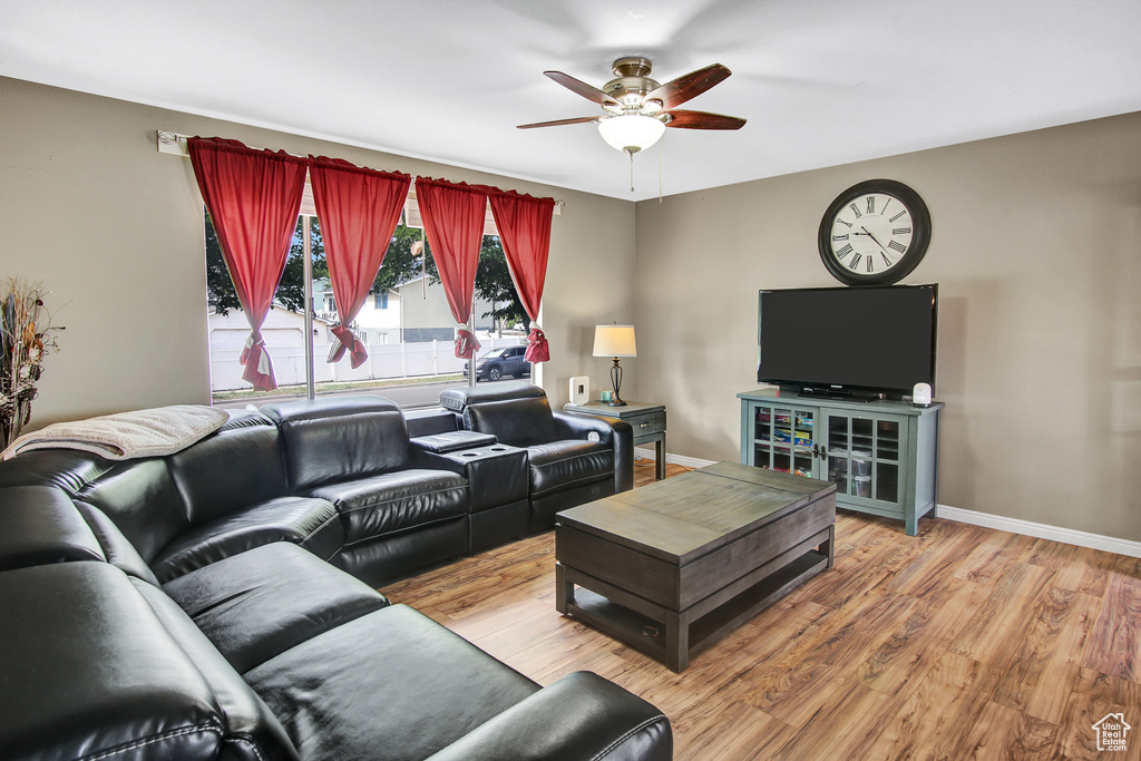 Living room with ceiling fan and wood finished floors
