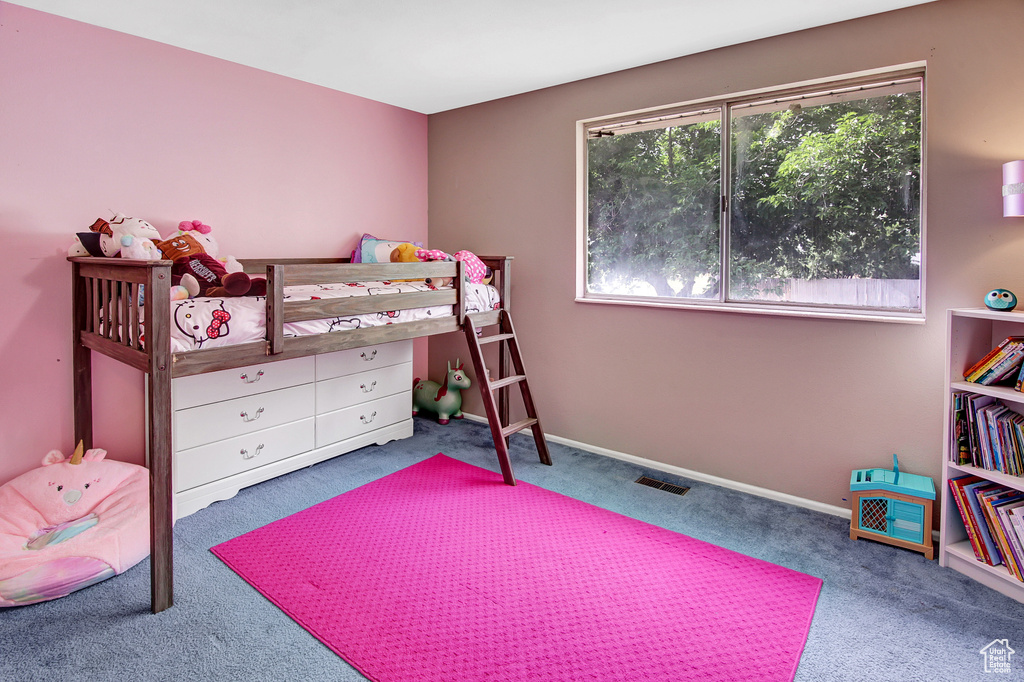 Bedroom featuring carpet floors and baseboards