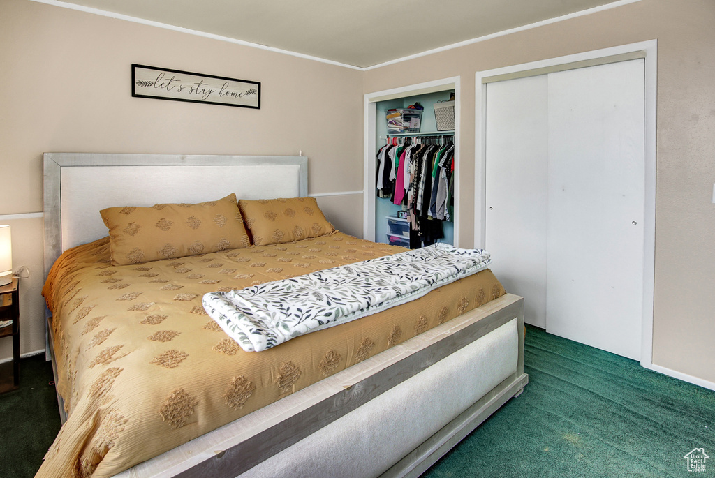 Carpeted bedroom featuring ornamental molding