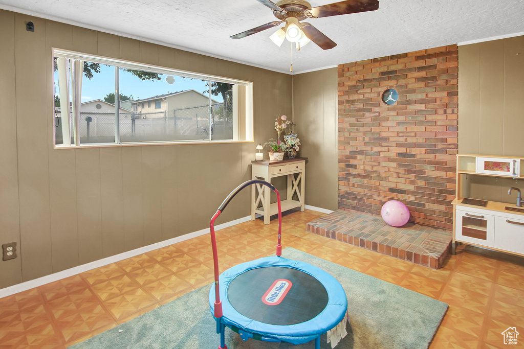 Game room featuring a textured ceiling and a ceiling fan