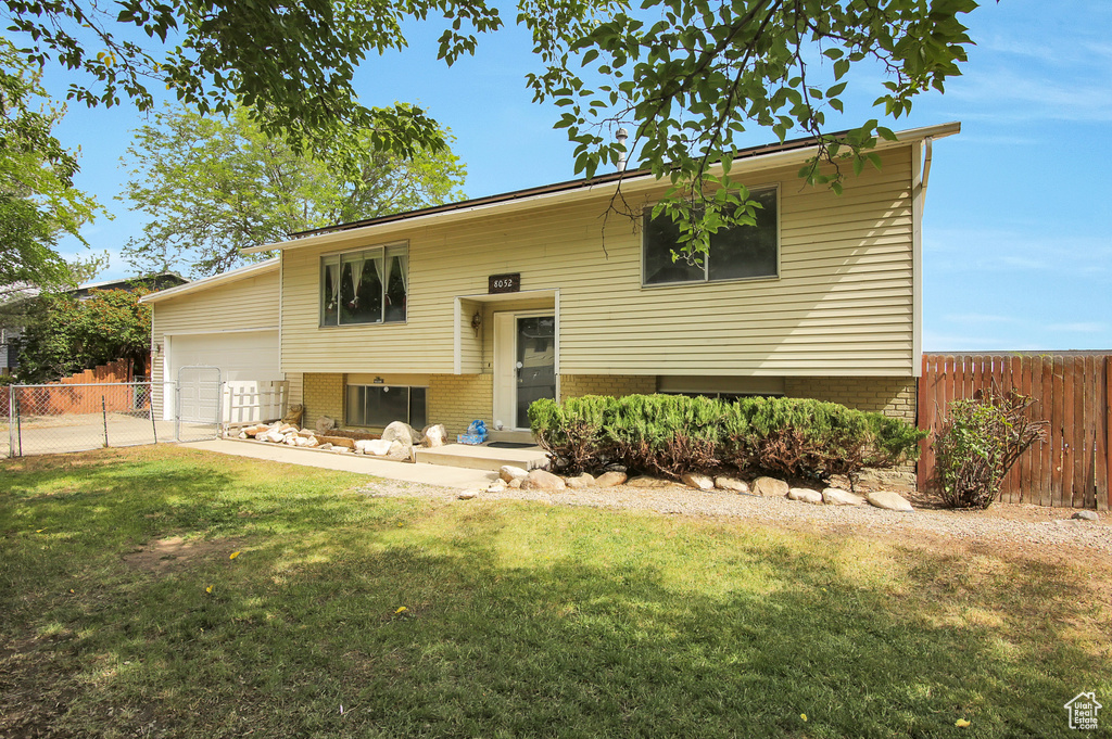 View of front of house with a garage and brick siding