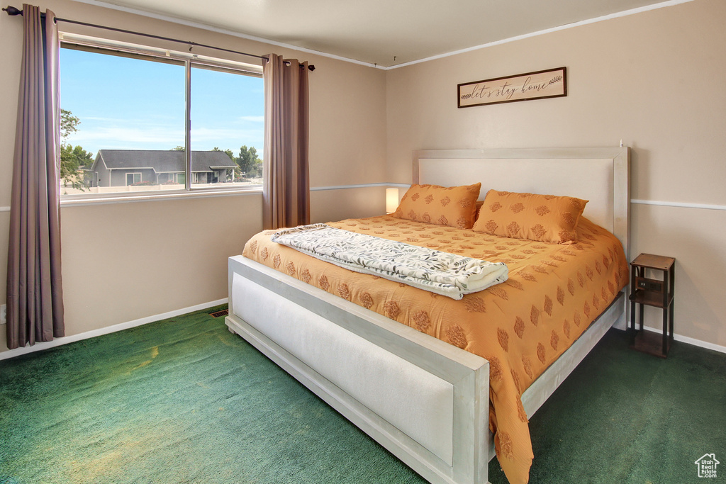 Carpeted bedroom featuring baseboards
