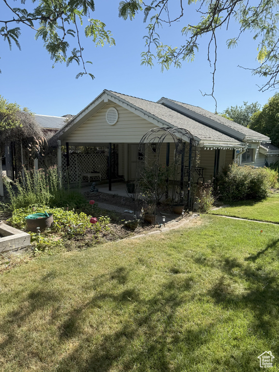 Back of property featuring a yard