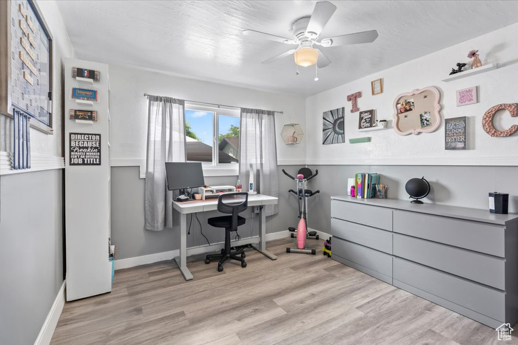 Office area featuring a ceiling fan and wood finished floors