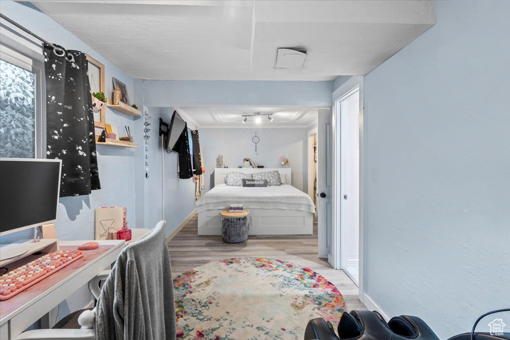 Bedroom featuring wood finished floors and baseboards