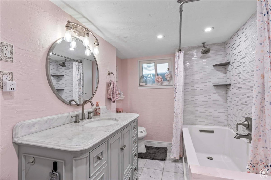 Full bathroom with vanity, shower / tub combo with curtain, recessed lighting, and tile patterned flooring