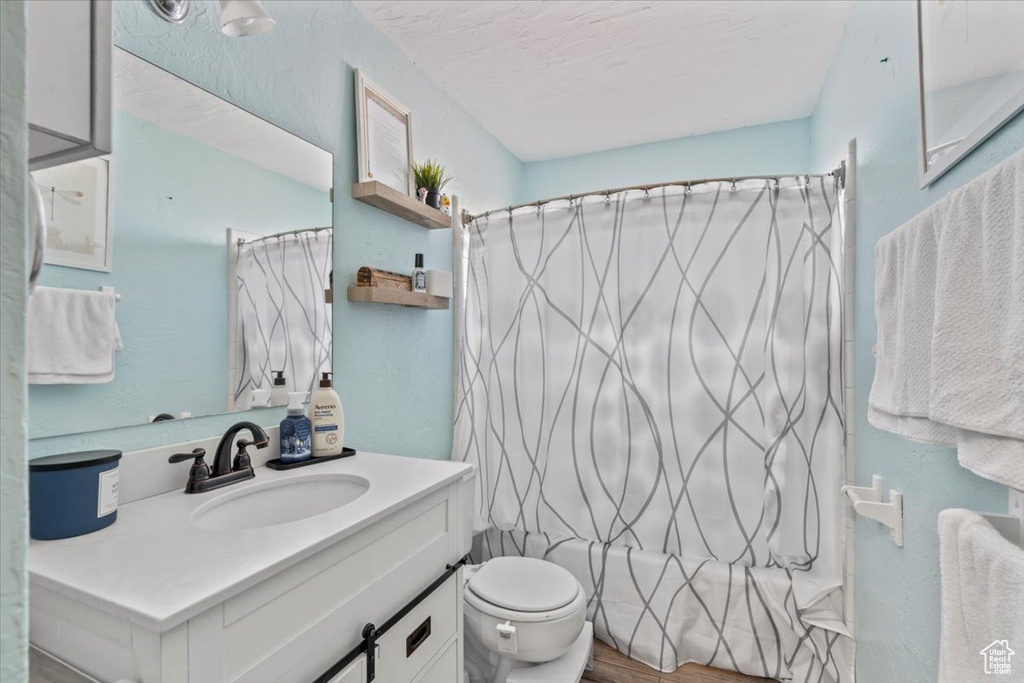Bathroom featuring vanity and shower / bathtub combination with curtain
